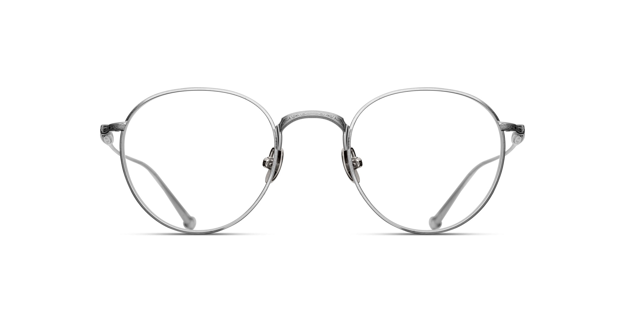 Matsuda M3085 optical frame in brushed silver, featuring a rounded P3-inspired silhouette with finely engraved metal rims, an intricately detailed bridge, adjustable nose pads, and slim titanium temples with sculpted tips.