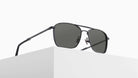 The Matsuda M3135 black aviator-style sunglasses with dark lenses are displayed on the edge of a white minimalist block against a plain white background.
