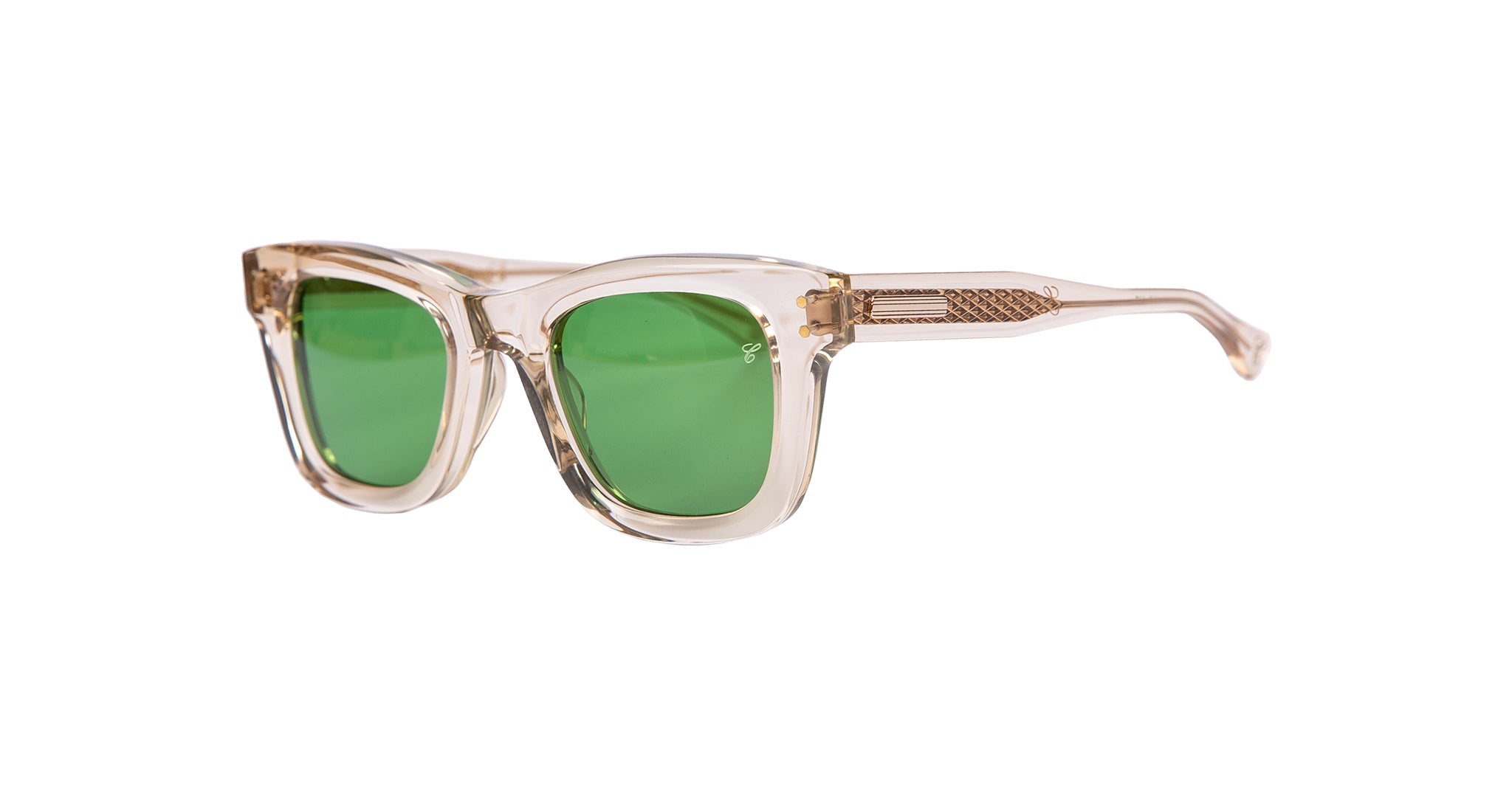 The Casinola x Native Sons “The E’s” (The Eddie) by Native Sons are clear-framed Wellington sunglasses featuring bold green lenses and textured gold detailing on the temples, crafted from premium Takiron acetate, shown against a white background.