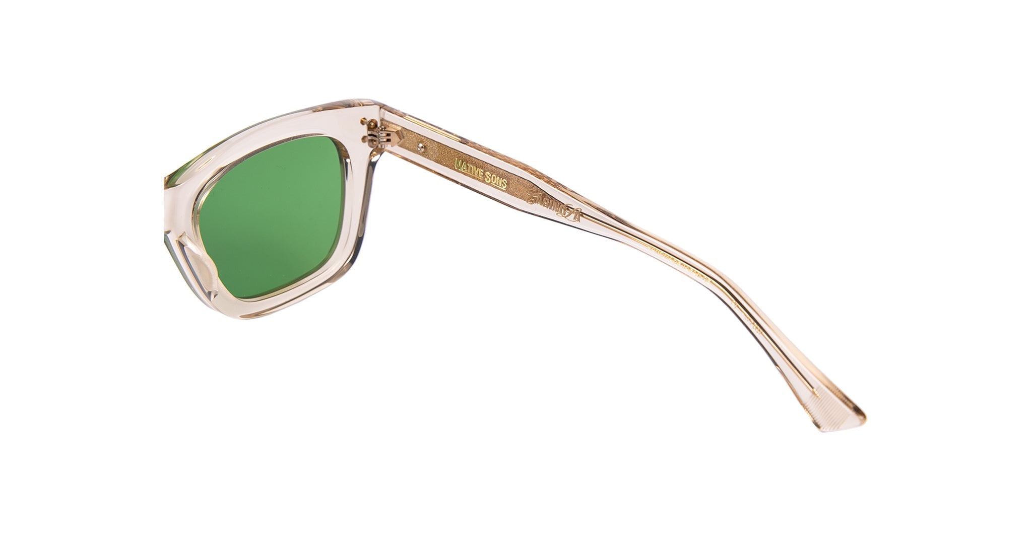 The Casinola x Native Sons “The E’s” (The Eddie) sunglasses by Native Sons feature handcrafted clear beige frames and green lenses, displayed from a side angle with one arm extended.