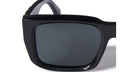 Close-up view of the left lens and frame of the Off-White Hays black rectangular sunglasses, highlighting the glossy finish and dark tinted lens.