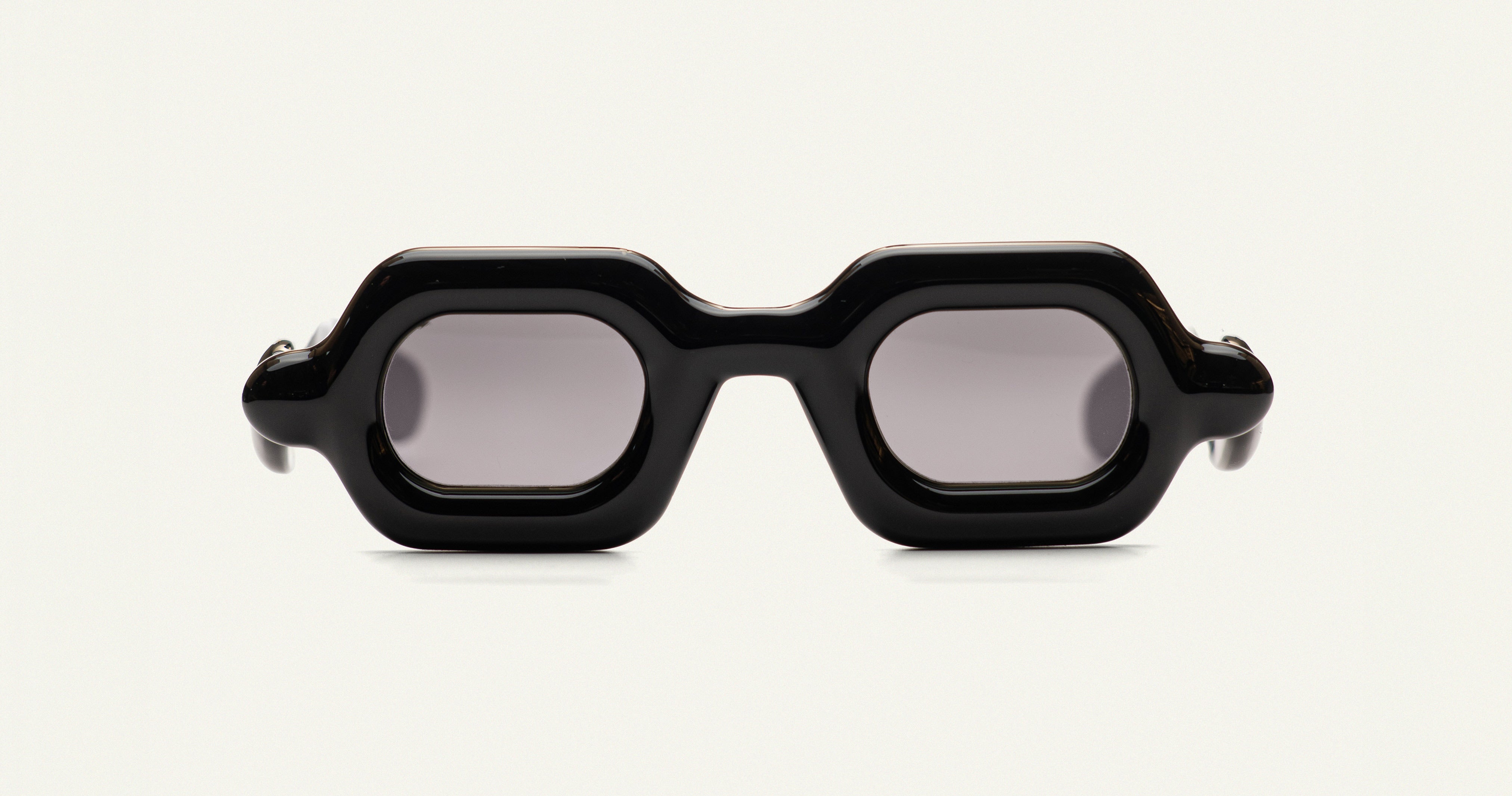 Paloceras Pebble SX sunglasses with glossy black frame and dark gray tinted lenses.