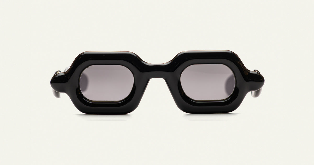 Paloceras Pebble SX sunglasses with glossy black frame and dark gray tinted lenses.
