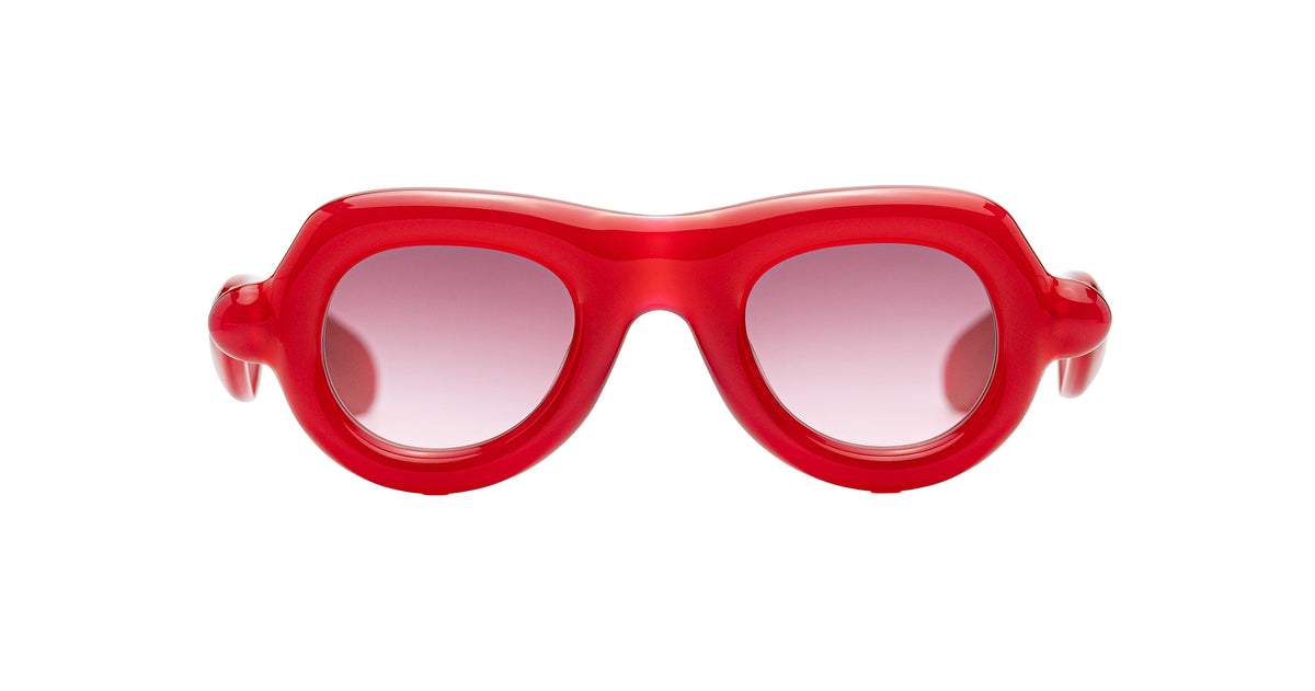 Red Aviator Paloceras Pebble sunglasses with a thick, rounded translucent frame and pink-tinted lenses