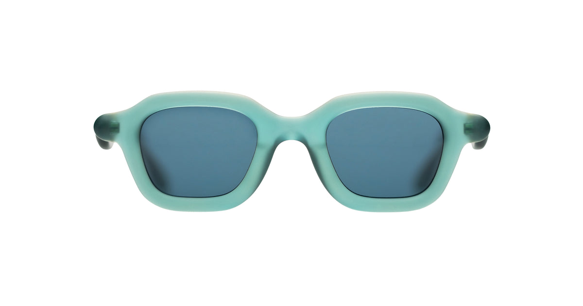 A pair of Paloceras trapeze-shaped sunglasses with a translucent mint green frame and dark blue-gray lenses, shown against a plain white background.