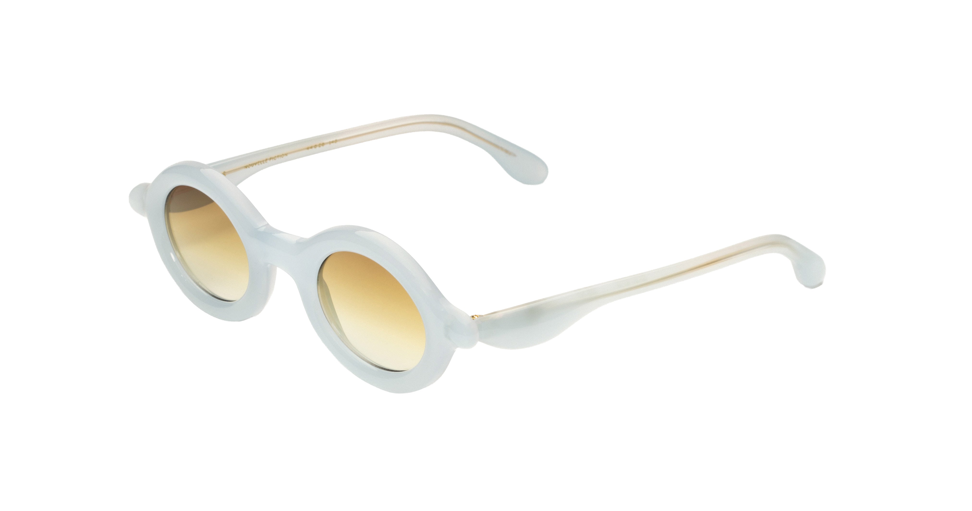 Paloceras Nouvelle Fiction R2 Milky Blue sunglasses in a pale translucent blue frame with thick rounded oval rims and warm golden gradient lenses, three-quarter view