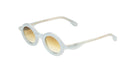 Paloceras Nouvelle Fiction R2 Milky Blue sunglasses in a pale translucent blue frame with thick rounded oval rims and warm golden gradient lenses, three-quarter view