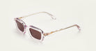 Paloceras S2 rectangular sunglasses in Liquid Pink, a translucent pale pink frame with rose-brown lenses, angled view