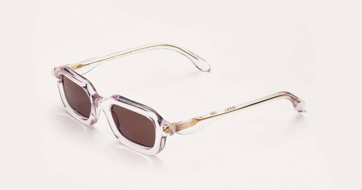Paloceras S2 rectangular sunglasses in Liquid Pink, a translucent pale pink frame with rose-brown lenses, angled view