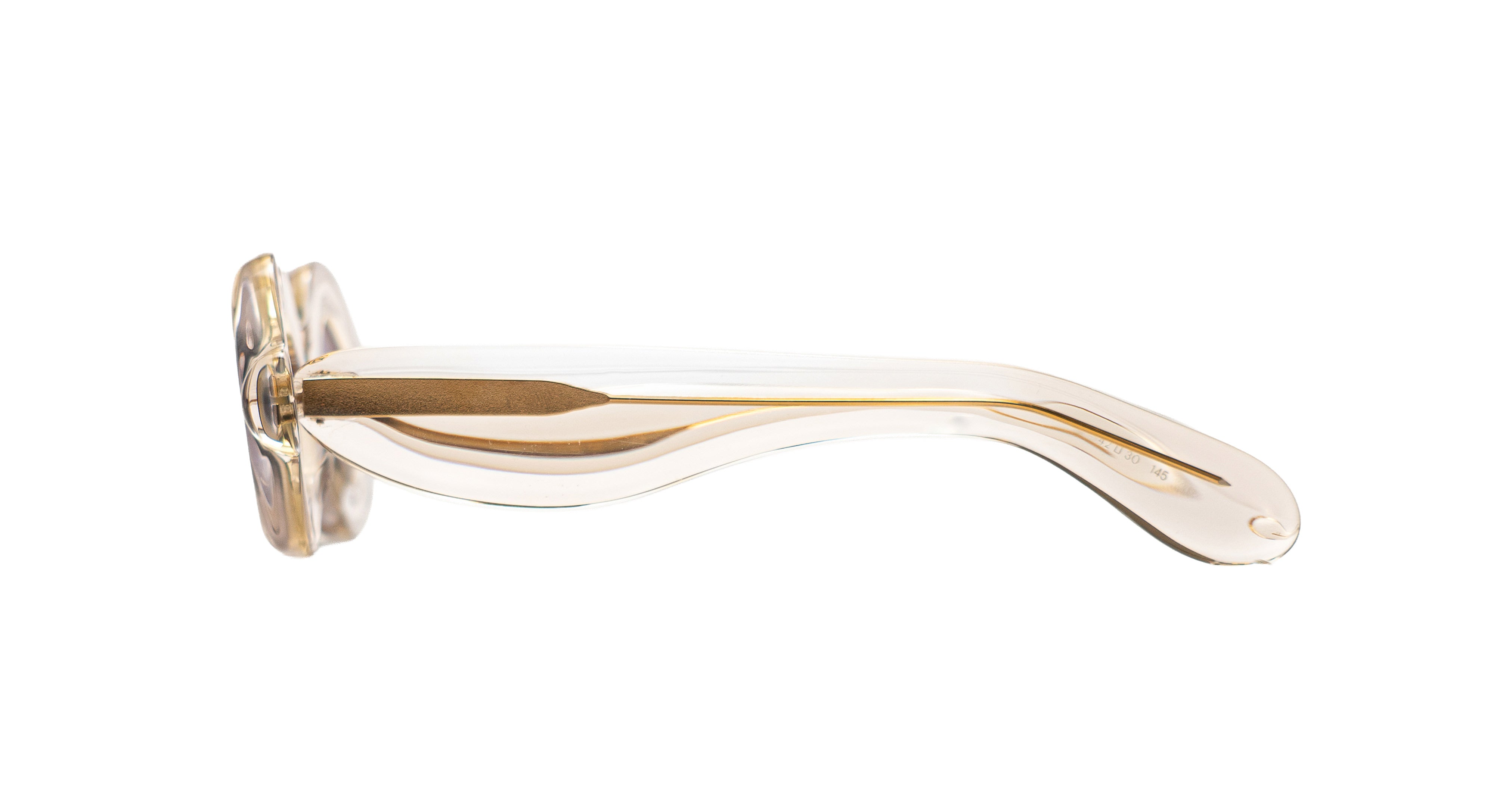 Paloceras Pebble RX Dulce Gloss sunglasses in a clear champagne frame with wide sculpted temples and gold-tone details, side view