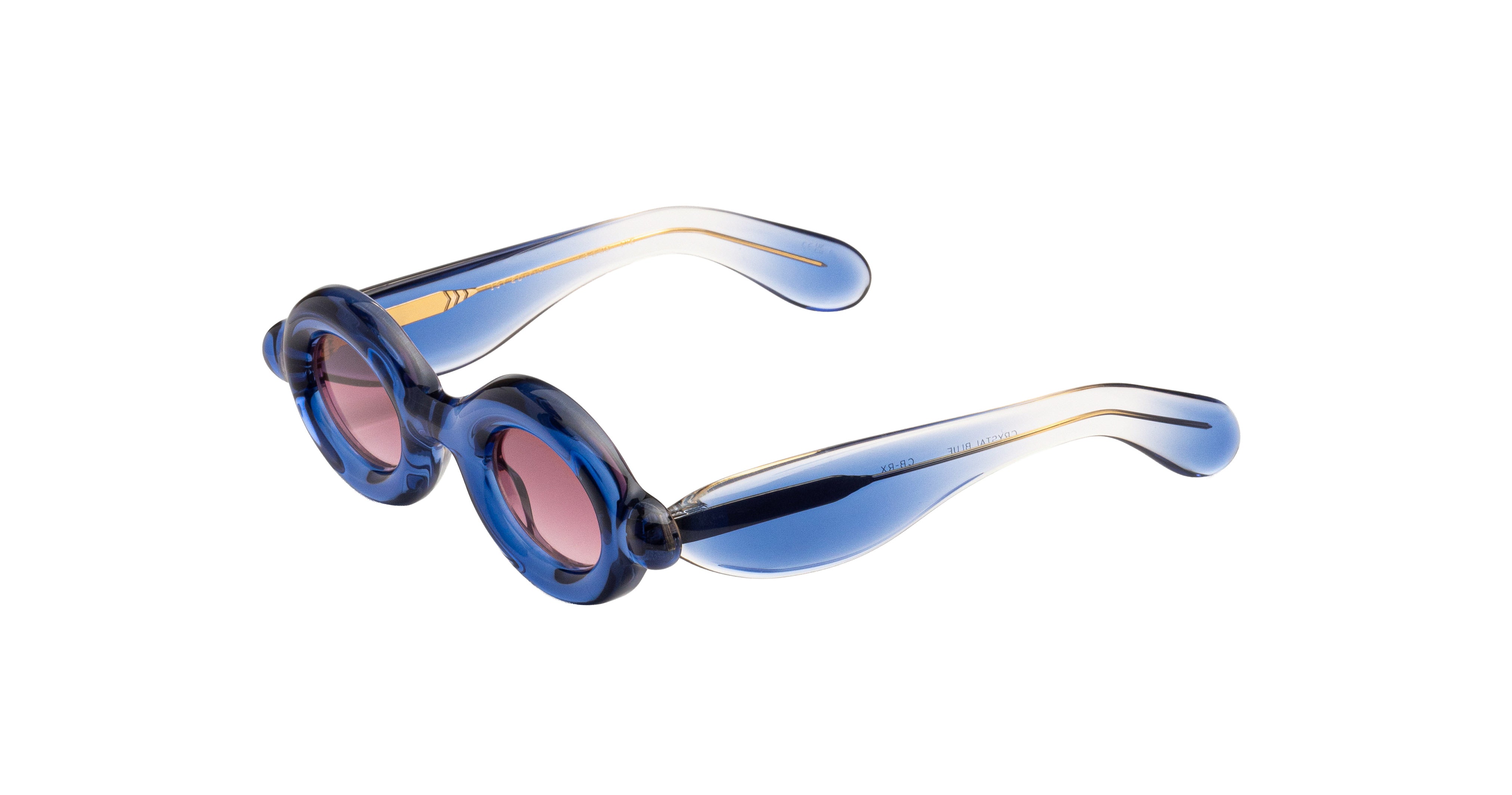Paloceras Pebble RX oval sunglasses in Ice Blue, with a translucent blue frame and pink lenses, angled view.