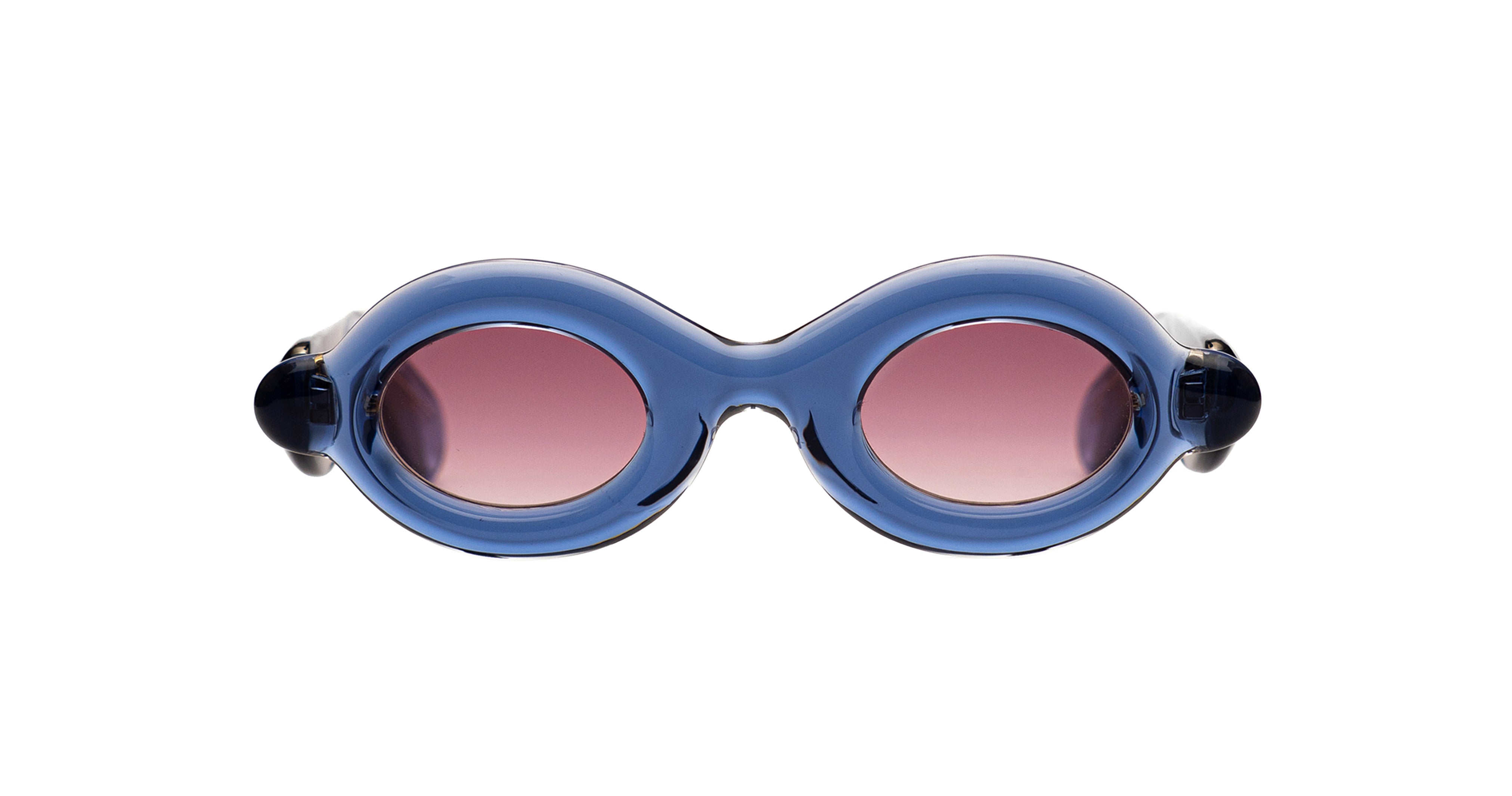 Paloceras Pebble RX oval sunglasses in Ice Blue, with a translucent blue frame and pink lenses, front view.