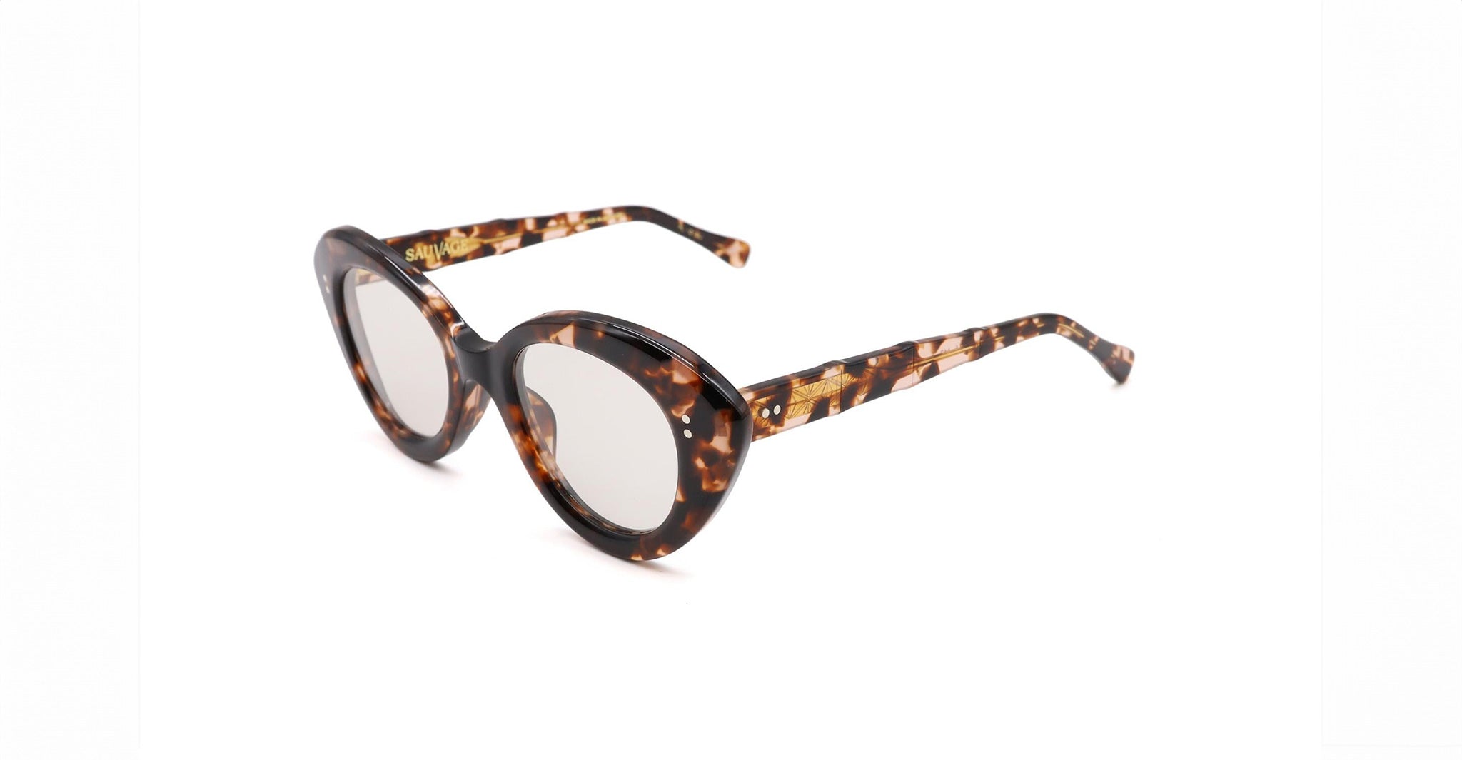 The Sauvage Libertine sunglasses feature brown tortoiseshell oval lenses with thick frames and arms, displayed on a white background.