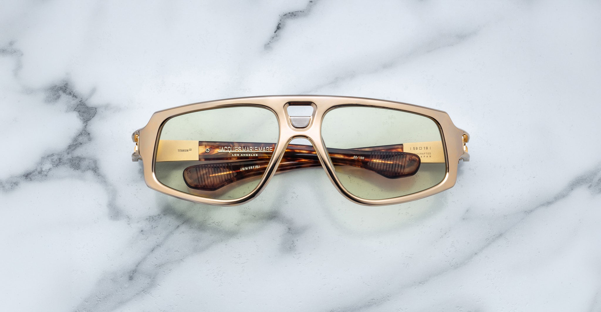 Jacques Marie Mage Scarface sunglasses with green lenses and tortoiseshell arms, top view.