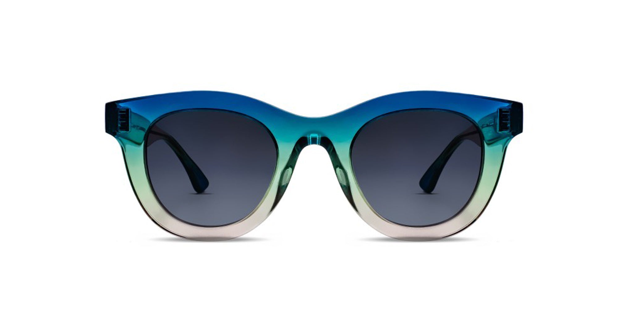 The Thierry Lasry Consistency sunglasses feature large, rounded frames that fade from dark blue at the top to light green and beige at the bottom, complemented by dark tinted lenses and wide arms.