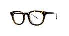 The Thierry Lasry Frenety eyeglasses feature round rectangular lenses and a black-and-brown tortoiseshell frame with thin, outward-curving temples, set against a plain white background.