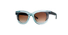 A pair of stylish sunglasses with transparent blue frames and brown gradient lenses, displayed on a white background.