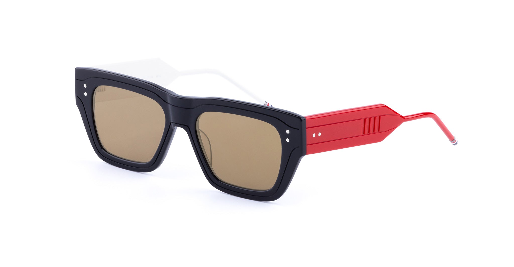 Rectangular Thom Browne sunglasses with thick black frames, brown lenses, and wide red arms featuring a geometric design. The arms have a metallic accent near the ear tips.