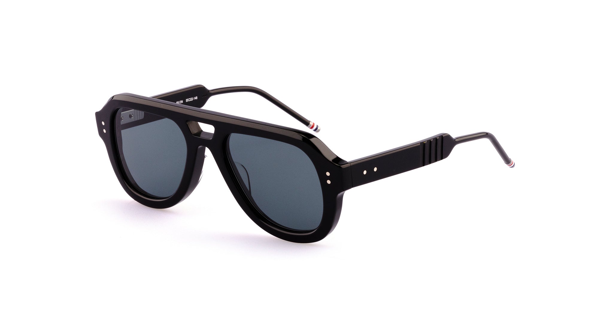 The Thom Browne 923 sunglasses in black feature thick frames, dark tinted lenses, slim metal arms with red, white, and blue stripe tips, and three metallic dots on each side of the frames.