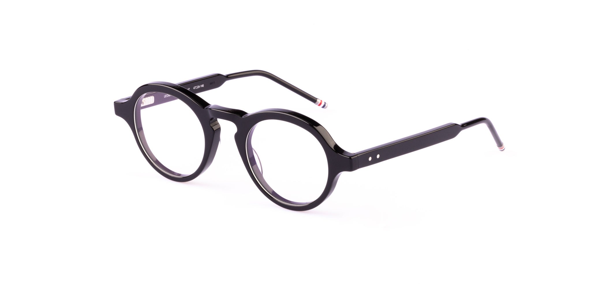 The Thom Browne 926 is a pair of black, round eyeglasses with thick frames, clear lenses, silver dot details on the temples, and red, white, and blue striped tips—shown on a white background.