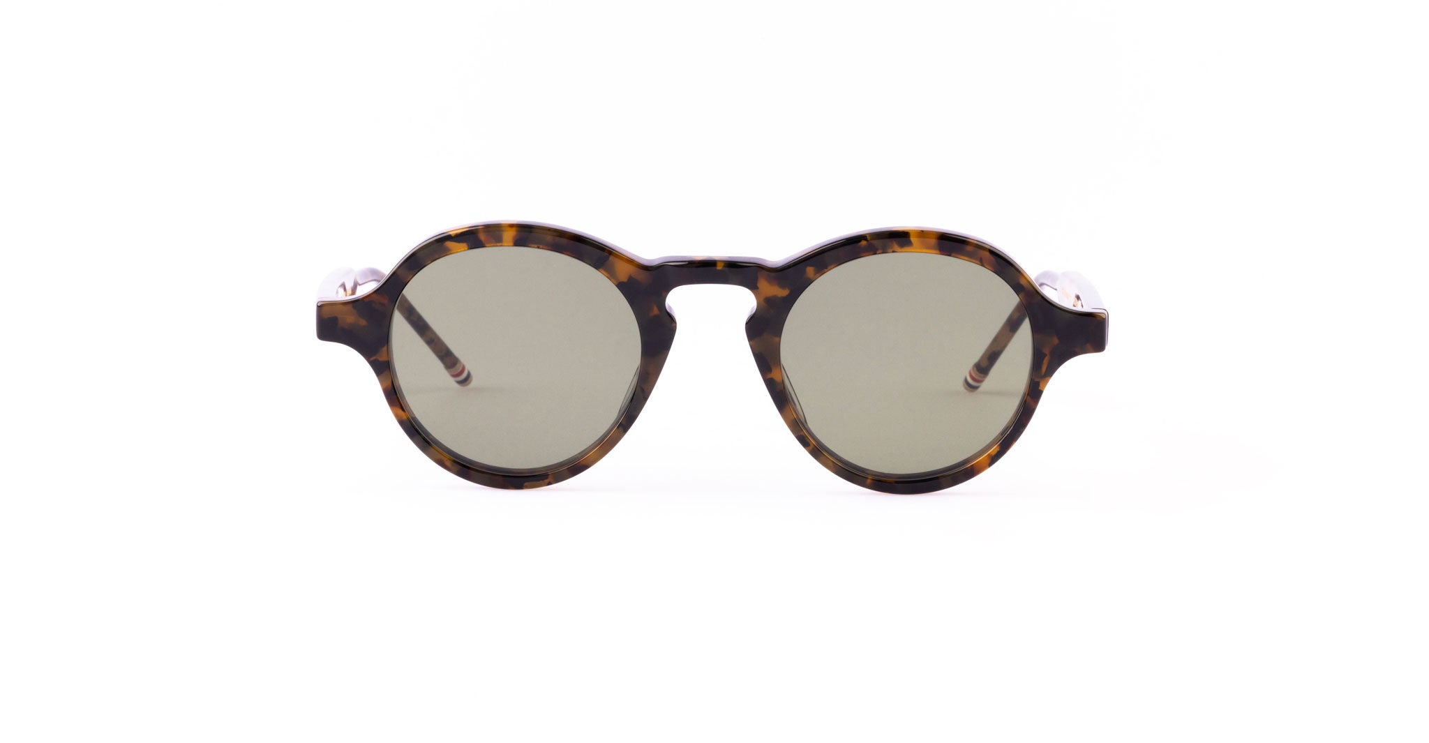 The Thom Browne 926 round sunglasses feature tortoiseshell frames and dark lenses, shown from the front on a plain white background.