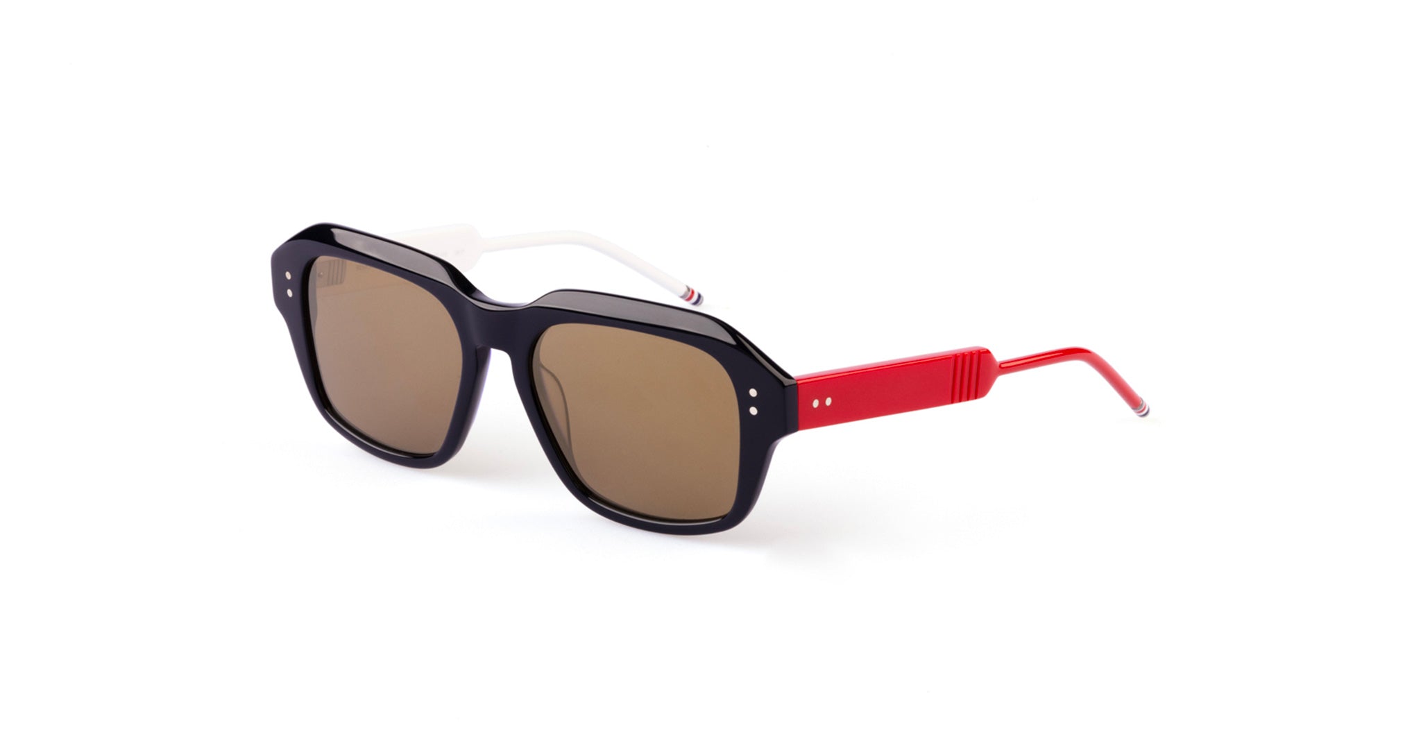A pair of rectangular Thom Browne sunglasses with a black front frame, brown-tinted lenses, white temples, and red earpieces, placed on a white background.