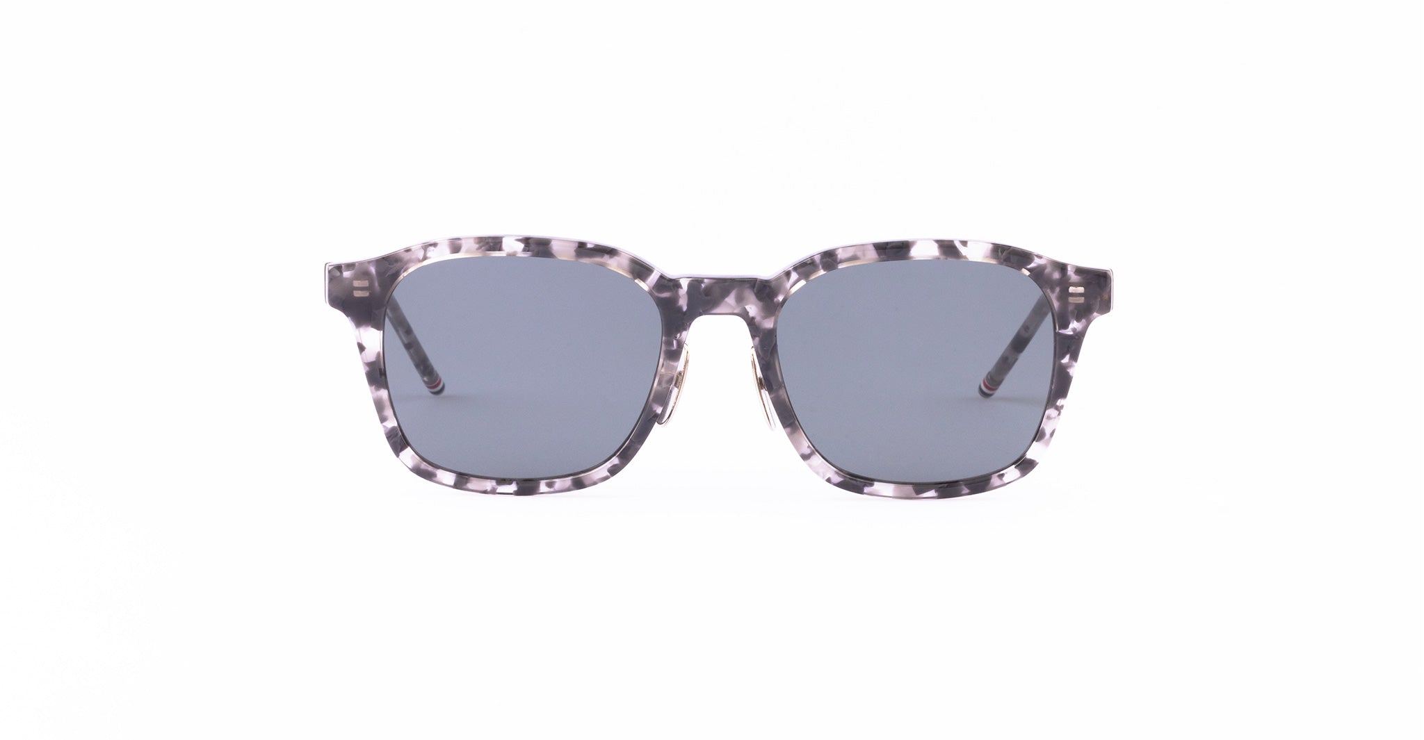 A pair of square sunglasses with gray lenses and a black-and-white tortoiseshell patterned frame, viewed from the front.