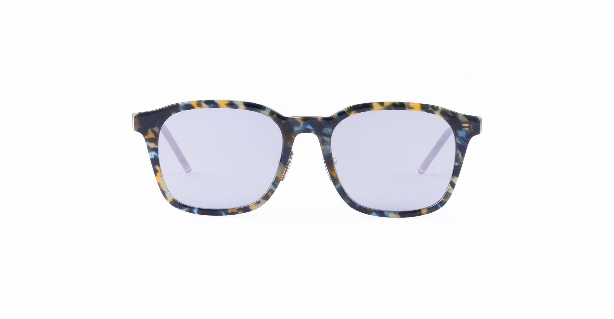 A pair of rectangular sunglasses with a multicolored tortoiseshell frame and light tinted lenses.