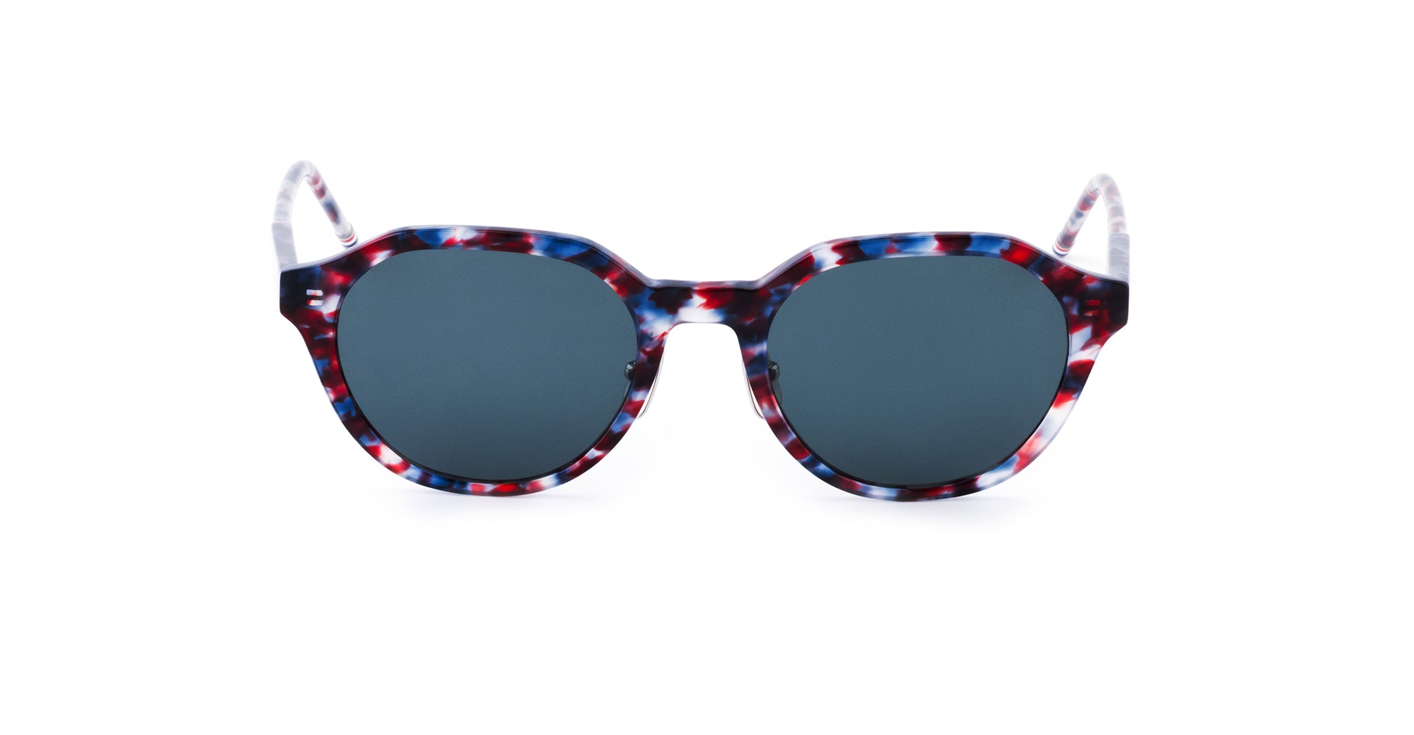 Sunglasses with round dark lenses and a thick, multicolored frame featuring a red, white, and blue tortoiseshell pattern.