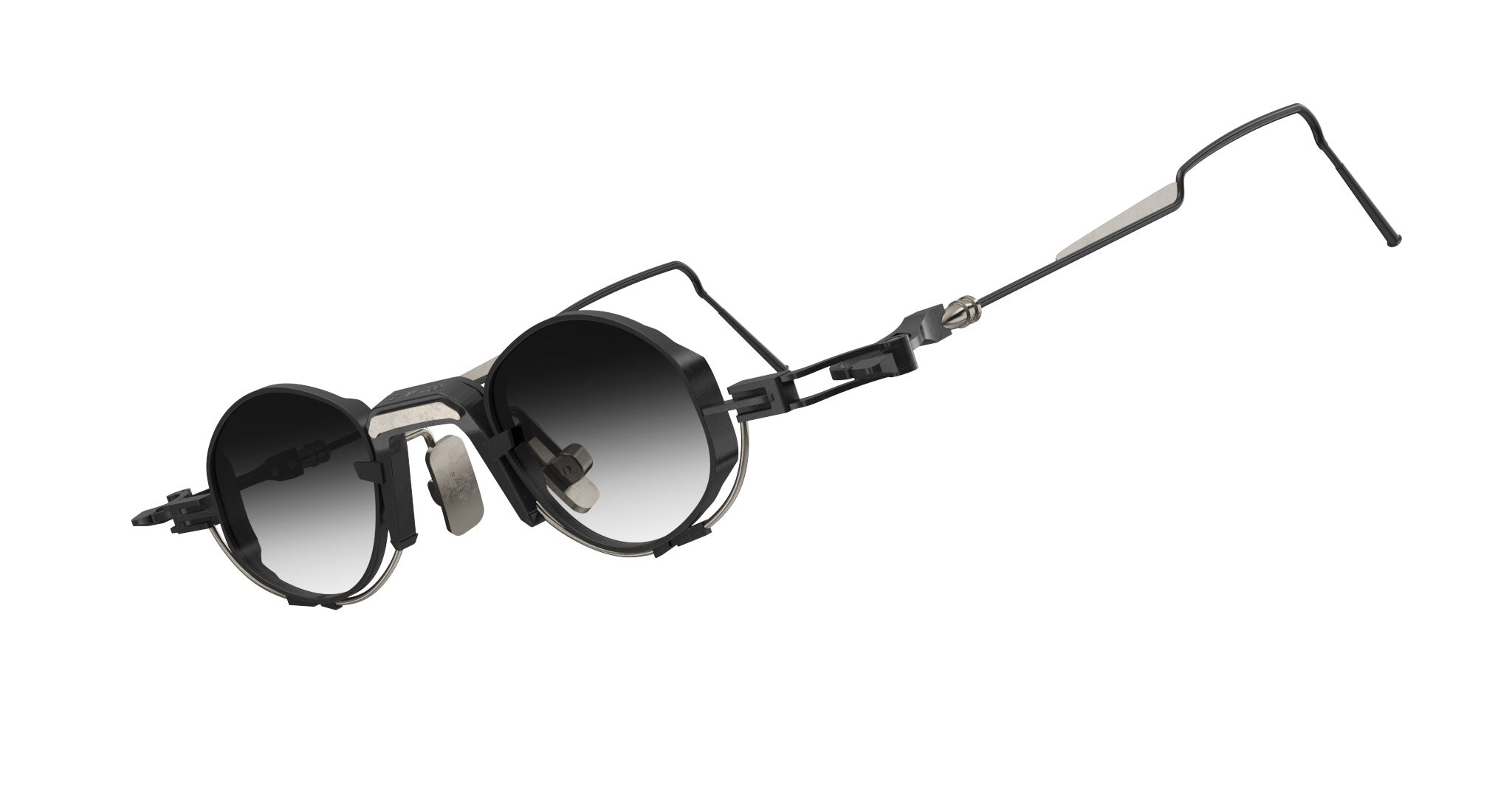 The VOA Nivara features round, black sunglasses with a metal frame, dark gradient lenses, and angular adjustable arms—a minimalist optical design displayed on a white background.