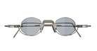 Front view of VOA Nivara round metal frame sunglasses with blue-tinted lenses and a geometric bridge—minimalist, elegant eyewear set against a white background.