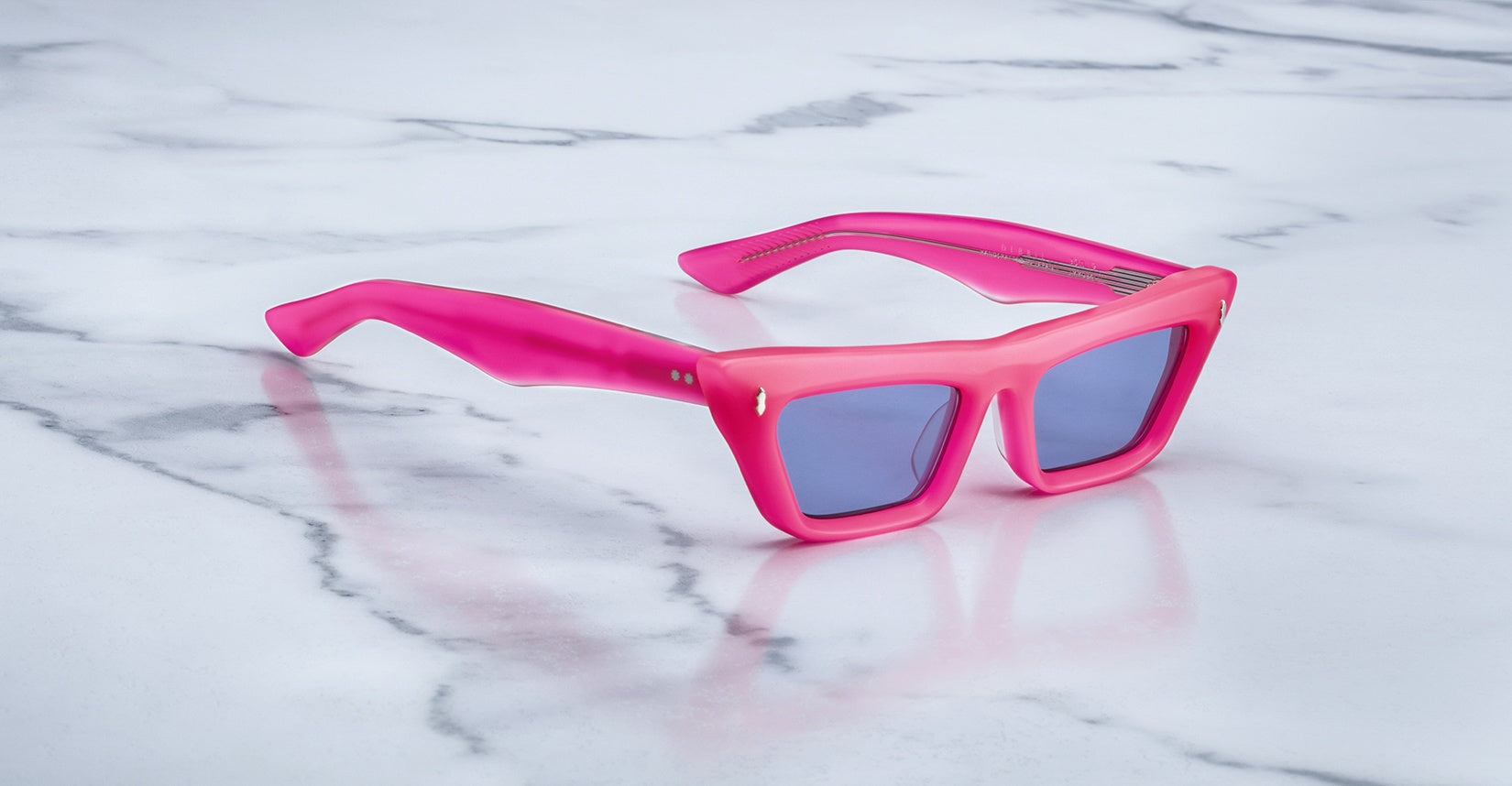 Jacques Marie Mage Debbie in Ultra Pink acetate cat-eye frame with blue-tinted lenses, featuring gold arrowhead pins and sculpted temples with exposed wirecore