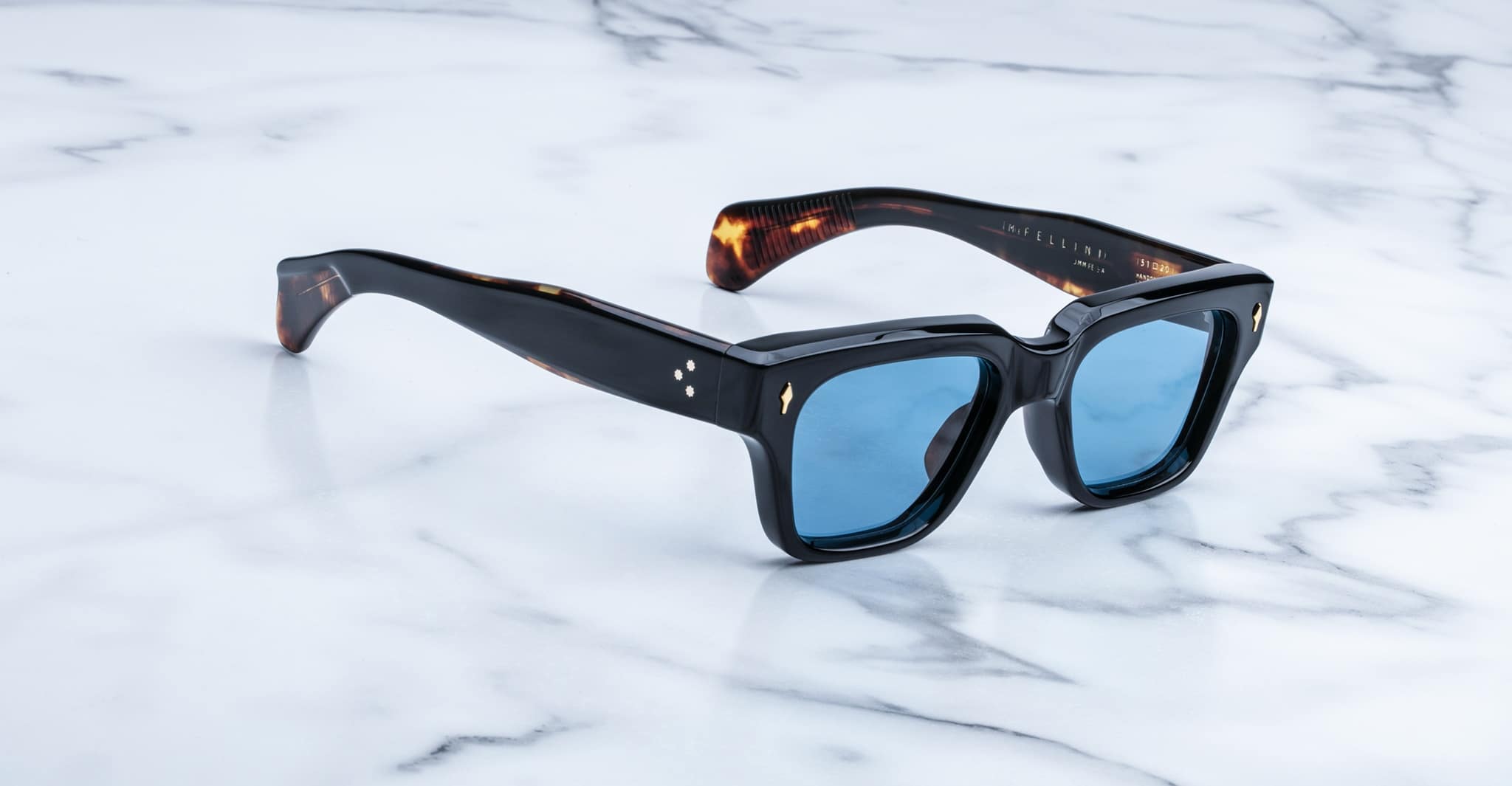 Jacques Marie Mage Fellini black rectangular sunglasses with blue lenses, top view.