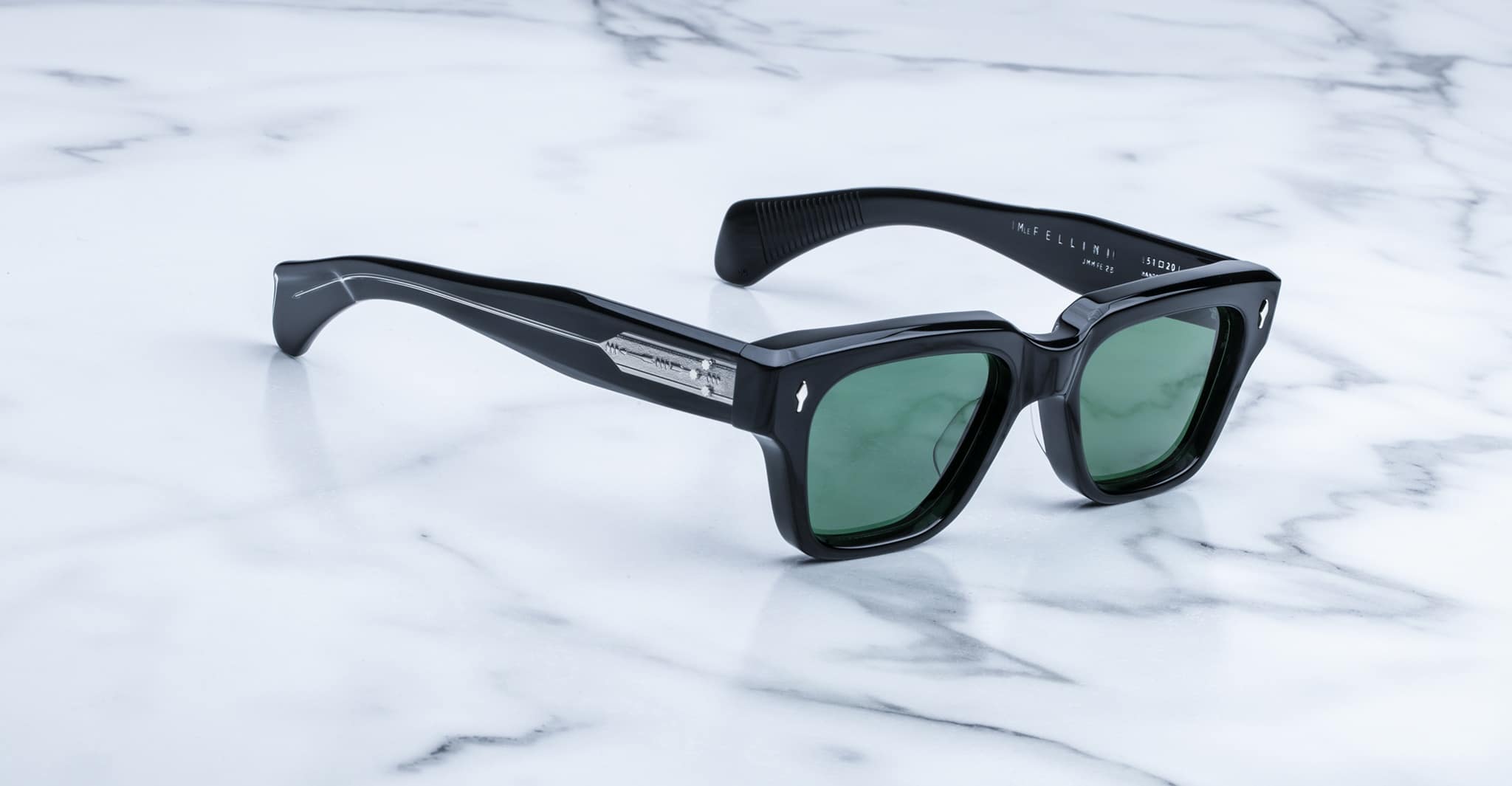 Jacques Marie Mage Fellini black rectangular sunglasses with green lenses, top view.