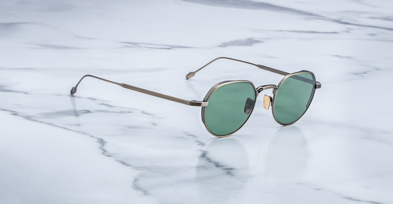 Angled view of the Jacques Marie Mage Fontana style sunglasses in colorway Gold Antique