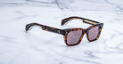 Jacques Marie Mage Molino tortoiseshell square sunglasses with pink-tinted lenses, top view.