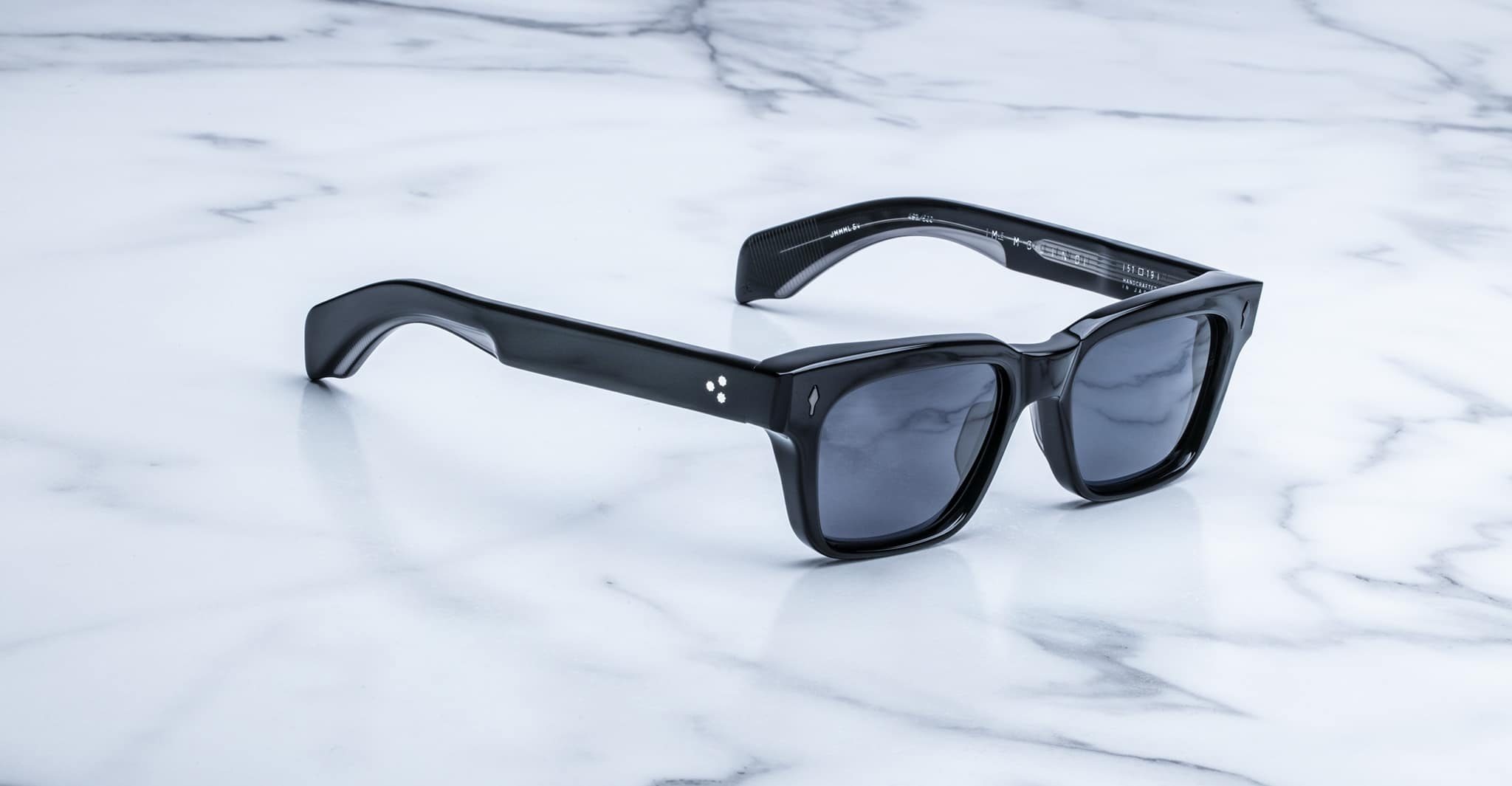 Jacques Marie Mage Molino black rectangular sunglasses with thick frames, shown from above.