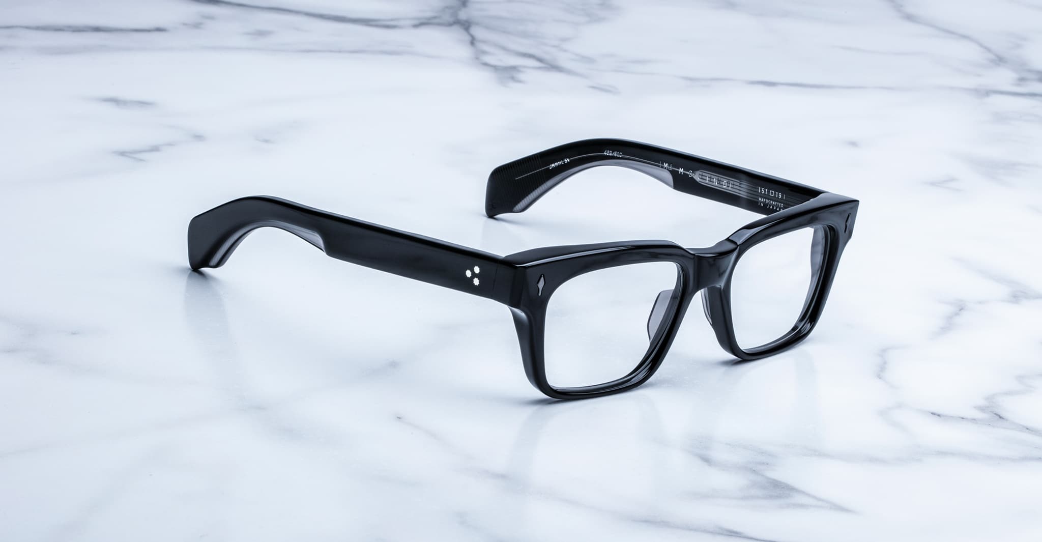 Jacques Marie Mage Molino black rectangular eyeglasses with thick frames, viewed from above.