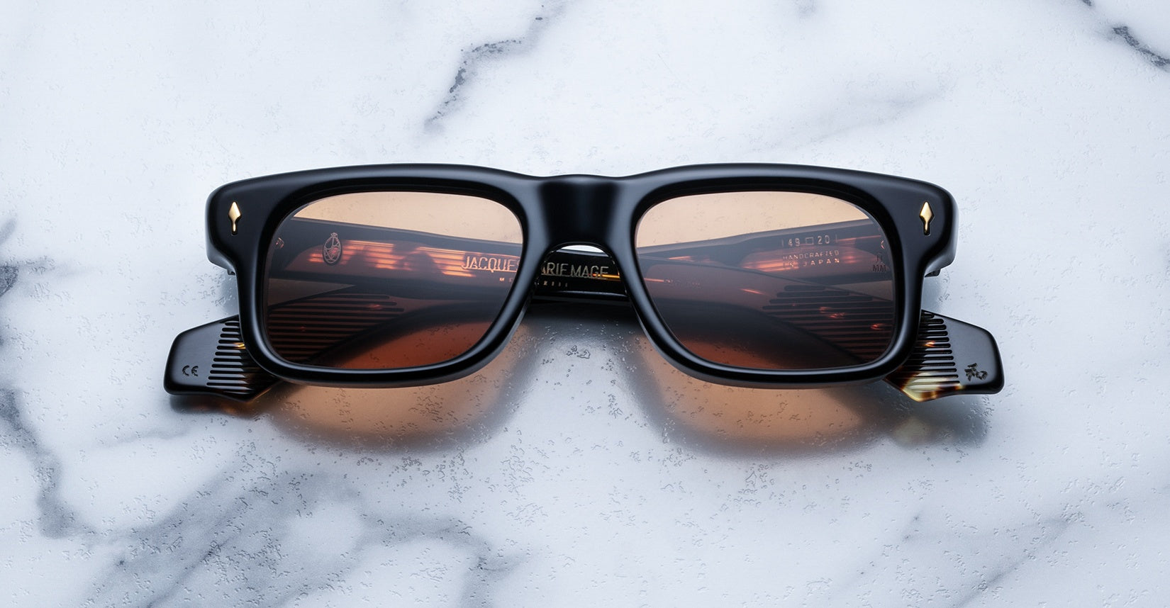 Jacques Marie Mage Saint black rectangular sunglasses with brown lenses, front view.