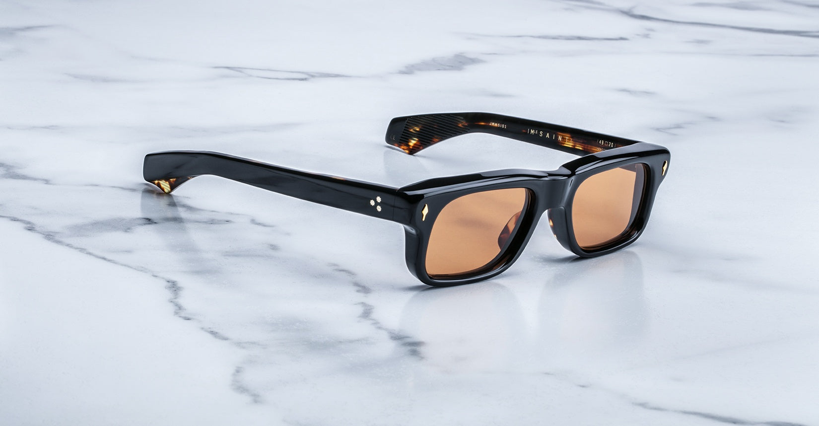 Jacques Marie Mage Saint sunglasses with black rectangular frames and brown lenses, viewed from the front.
