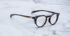 Jacques Marie Mage Sheridan in Dark Havana, rich tortoiseshell acetate glasses with sculpted brow and gold hardware, angled view