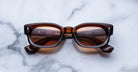 Jacques Marie Mage Whiskeyclone rectangular acetate sunglasses with thick frames, top view.