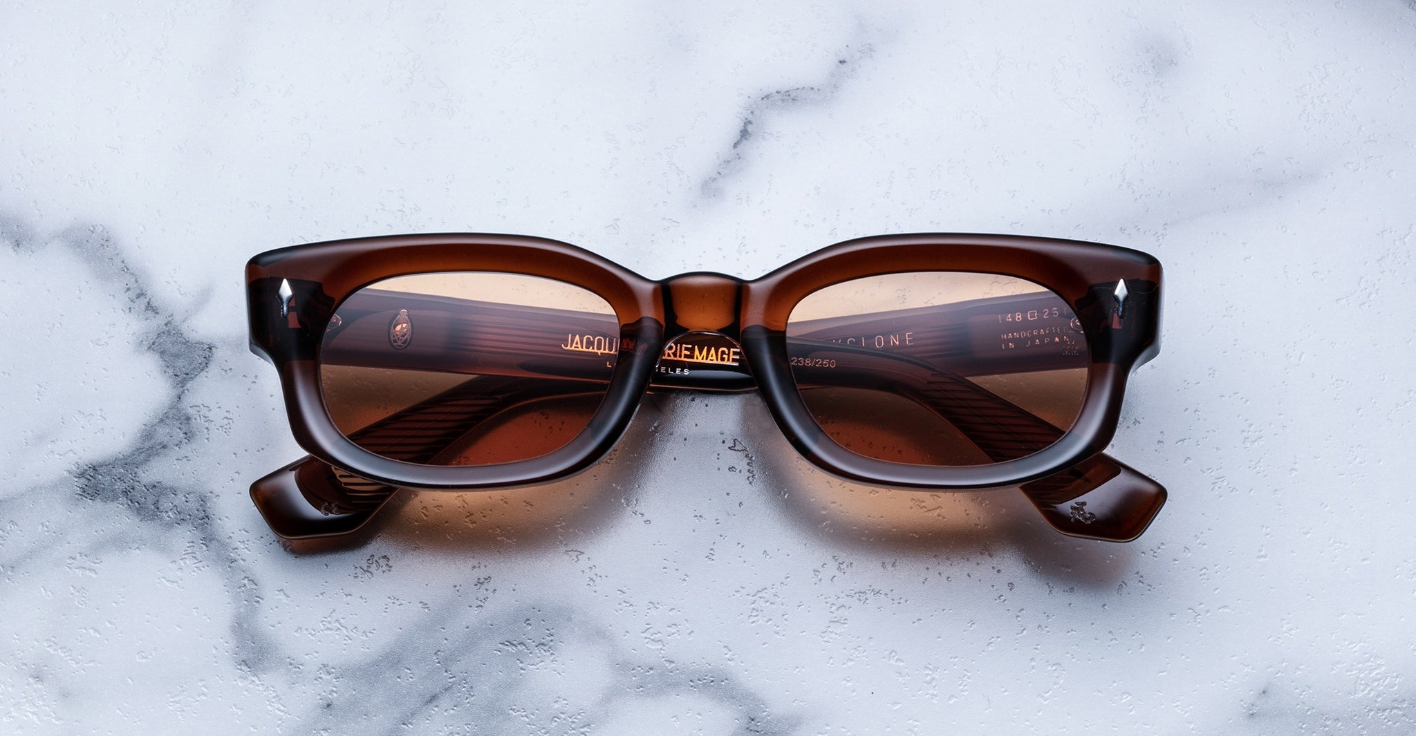 Jacques Marie Mage Whiskeyclone rectangular acetate sunglasses with thick frames, top view.