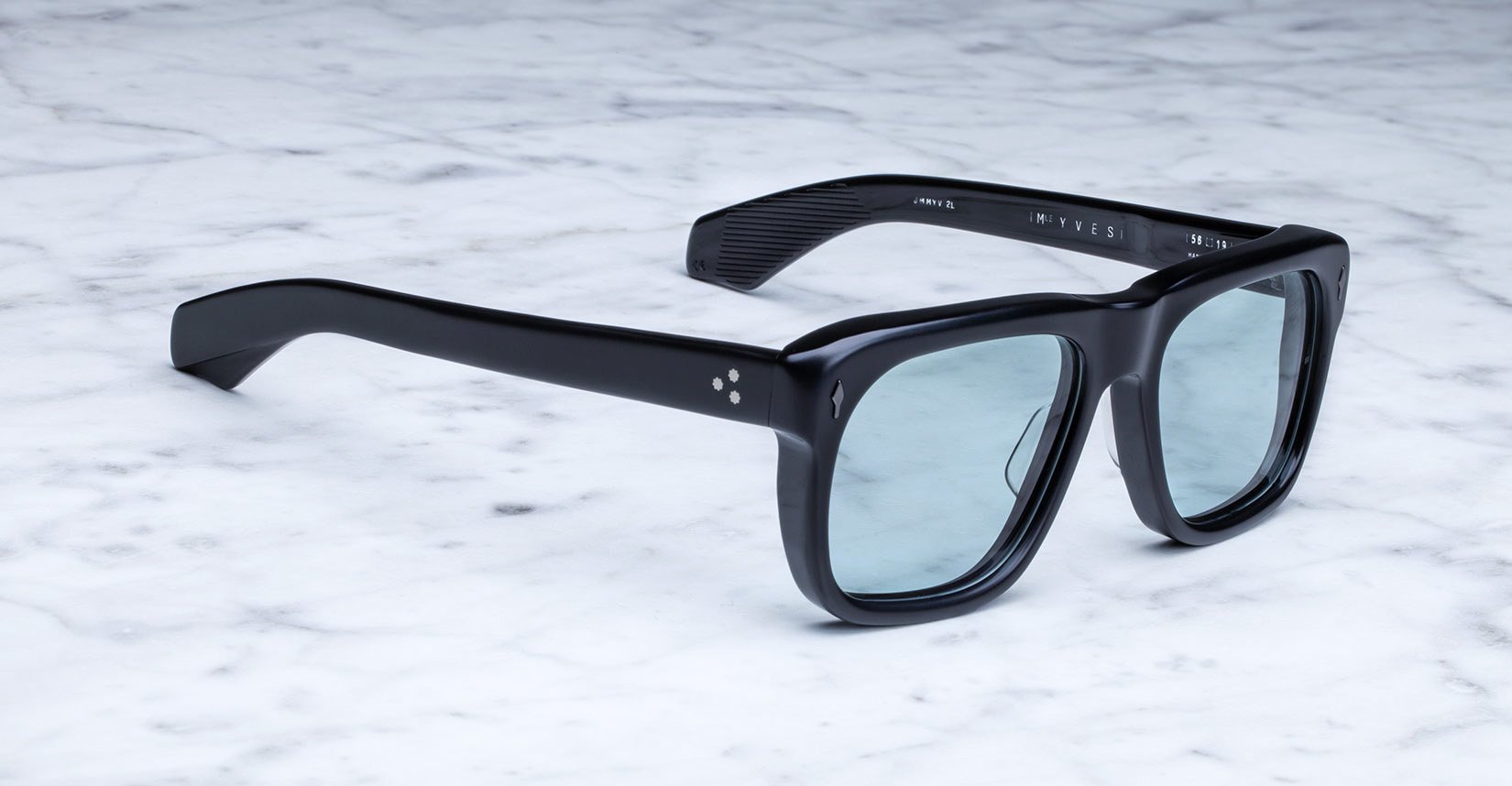 Jacques Marie Mage Yves black rectangular sunglasses with blue lenses, top view showing frames and tinted lenses.