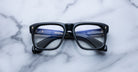 Jacques Marie Mage Yves black rectangular eyeglasses with blue temples, top view.