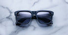 Jacques Marie Mage Yves black square-framed polarized sunglasses with dark lenses, top view.