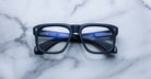 Jacques Marie Mage Yves black rectangular eyeglasses with blue accents, top view.