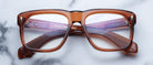 Jacques Marie Mage Yves brown rectangular eyeglasses with clear lenses, top view.