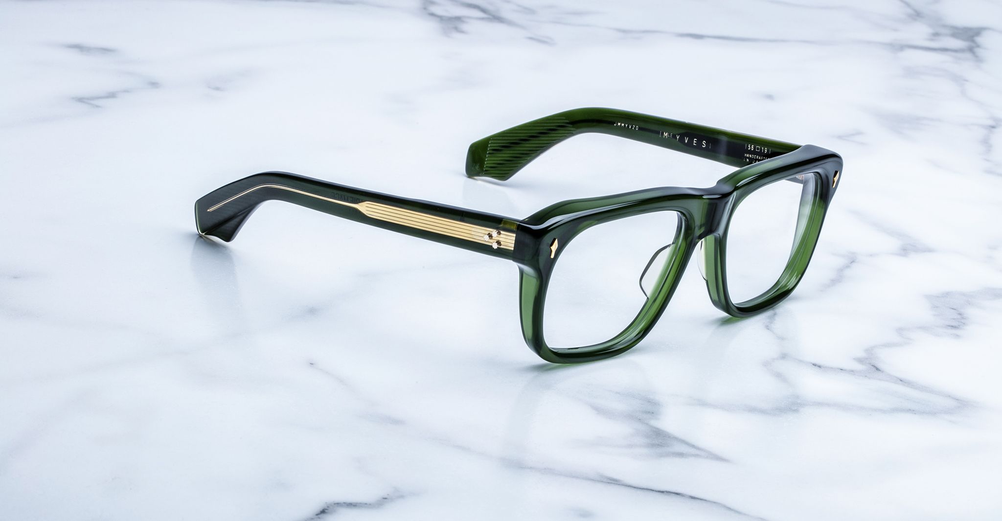 Jacques Marie Mage Yves green rectangular eyeglasses with gold accents, front angle view.