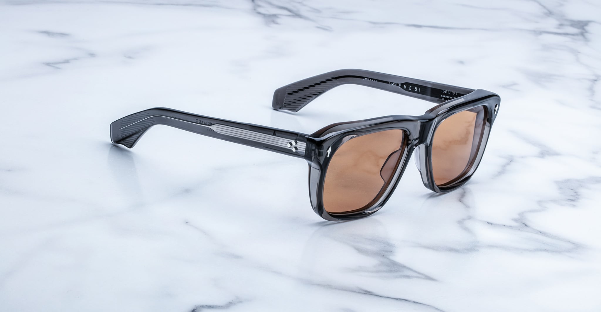 Jacques Marie Mage Yves black rectangular sunglasses with UV-protection brown lenses, top view.